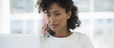 An employee in the office working on her laptop