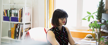 A woman working from her desk at home