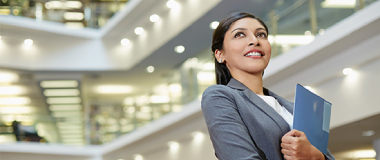 An employee standing in a giant office building