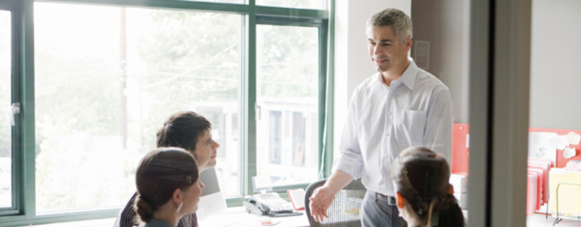 A manager leading his team in a meeting