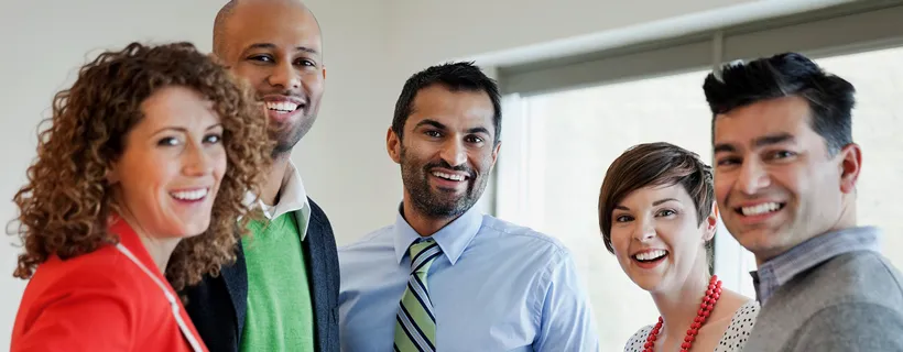 a group of coworkers smiling at the camera