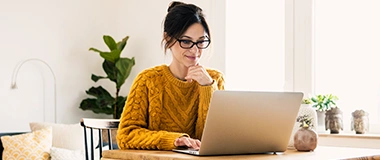 A woman on her laptop reading interview tips
