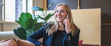 Woman in blazer talking on phone