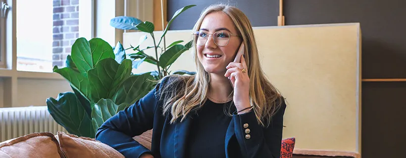 Female in blazer on mobile phone