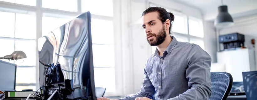 an Accounts Receivable working on his computer in the workplace