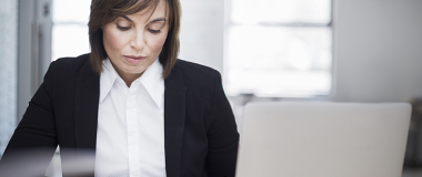 An employee working in the office looking stressed