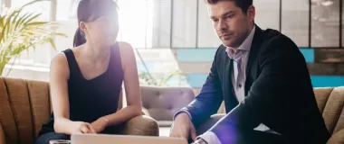 two colleagues looking at a computer screen