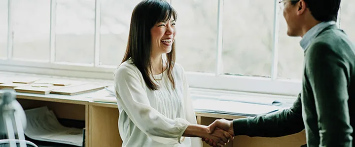 Two employees shaking hands