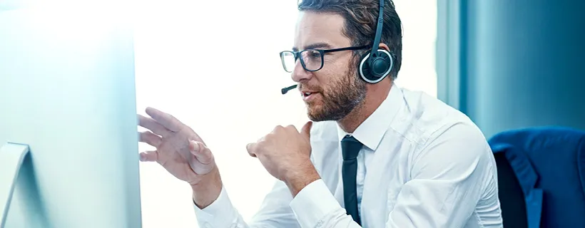 a Contracts Administrator with his headphones on talking