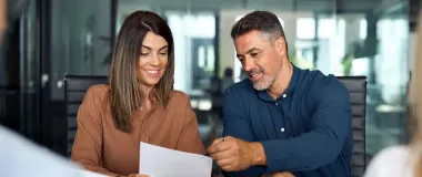 two colleagues looking at a piece of paper