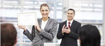 An employee holding an award she received