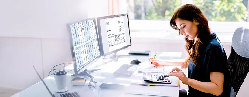 a Finance Officer making some calculations while taking notes