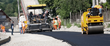 Construction vehicles and machinery paving out concrete