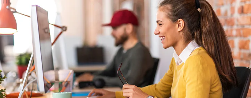 a woman looking at computer and laughing