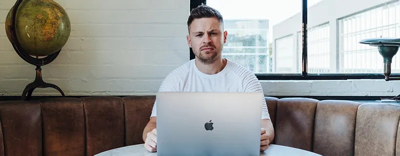 A man in a cafe on his laptop