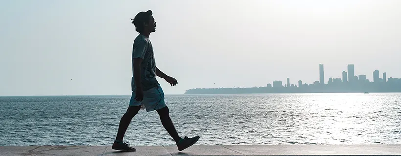 A person walking along side the ocean