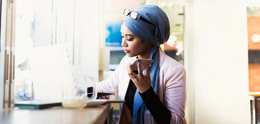 A woman on the phone in a cafe