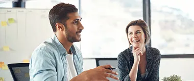 Two people in an office having a discussion