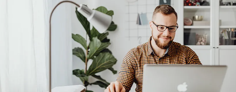 Man working on laptop to update Linkedin Profile 