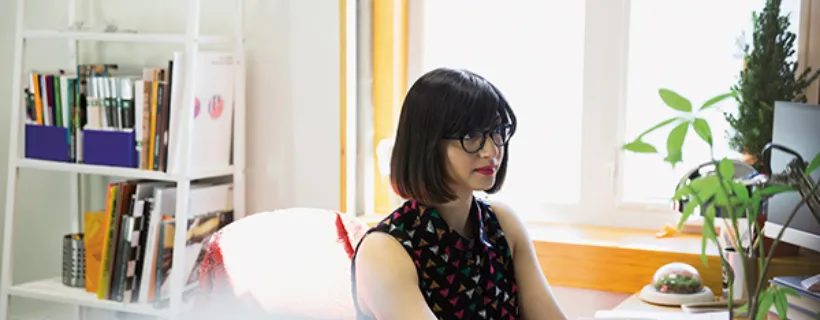 A woman working from home at her desk