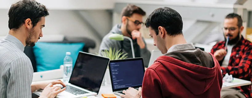 Four entreprenuers working in their office on their laptops