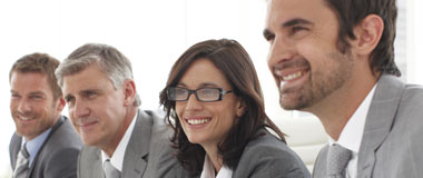 Employees sitting in a row at their desk