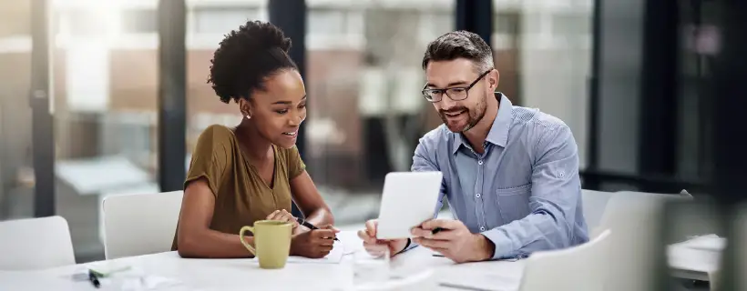 two people looking at a piece of paper