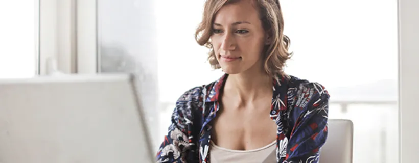 a woman working from home on her laptop