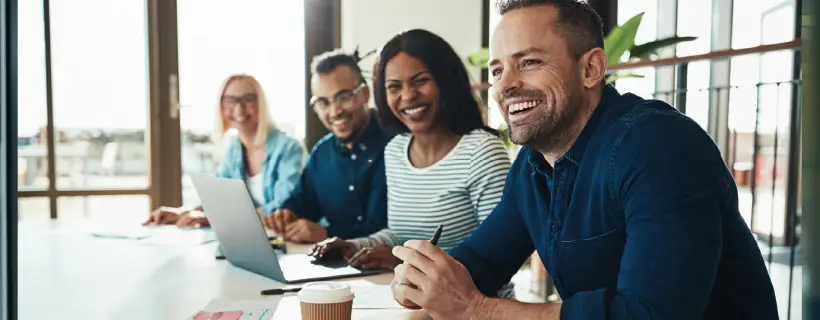 a group of people in a meeting setting 