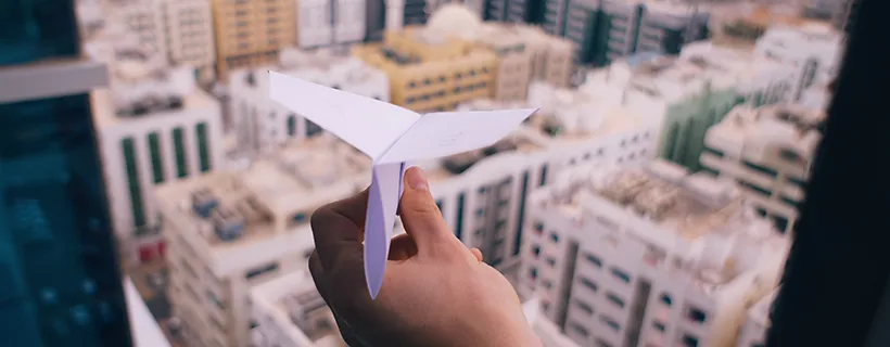 Someone about to launch a paper air plane into the city