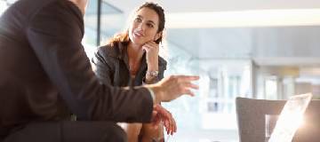 two co workers having a conversation in the office