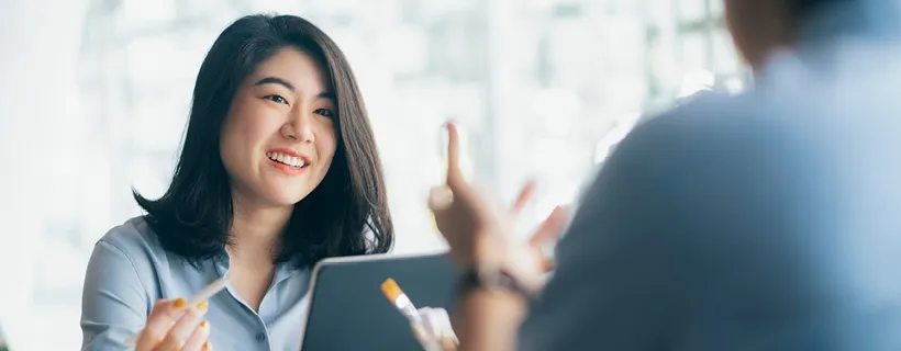 a woman talking to her colleague