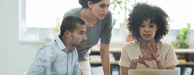 Three employees working together in the office