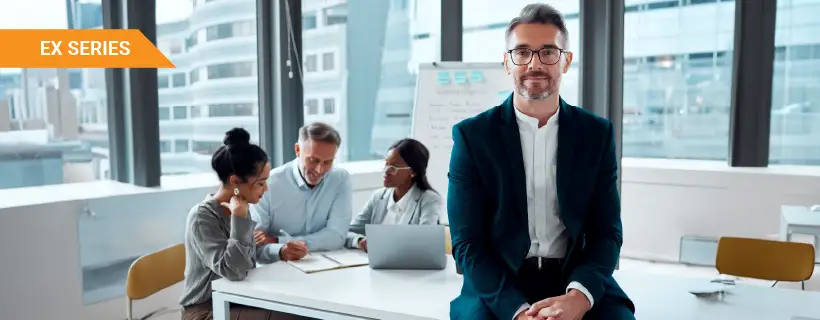 young male wearing glasses in a meeting room