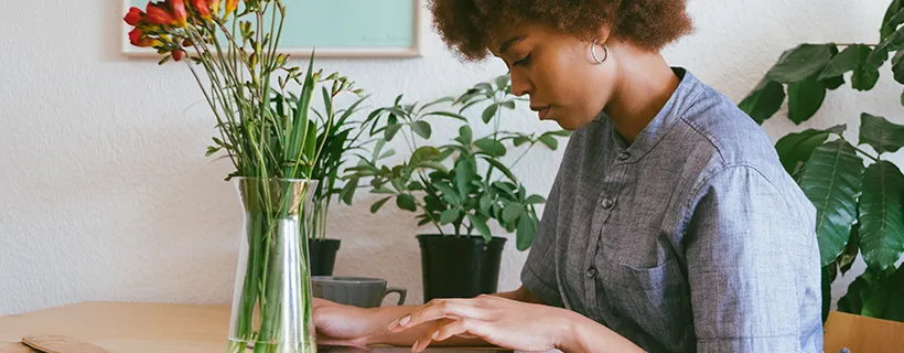 A woman sitting at her desk at home working