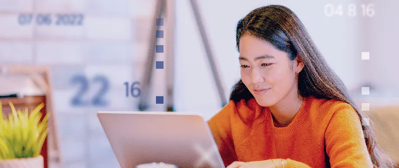 a woman looking at her laptop and smiling while learning