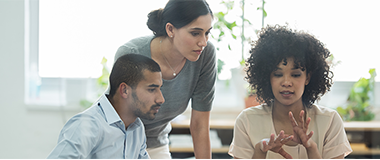 Three employees working together in the meeting room