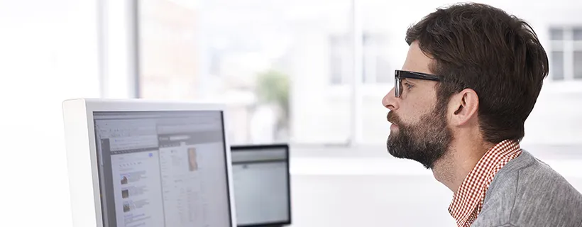 A man in the office working on his computer