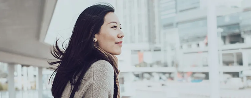 A woman looking out to the distance in the city