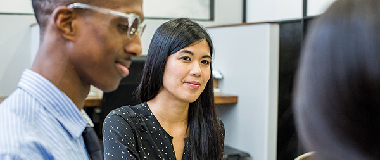 three employees talking in the office