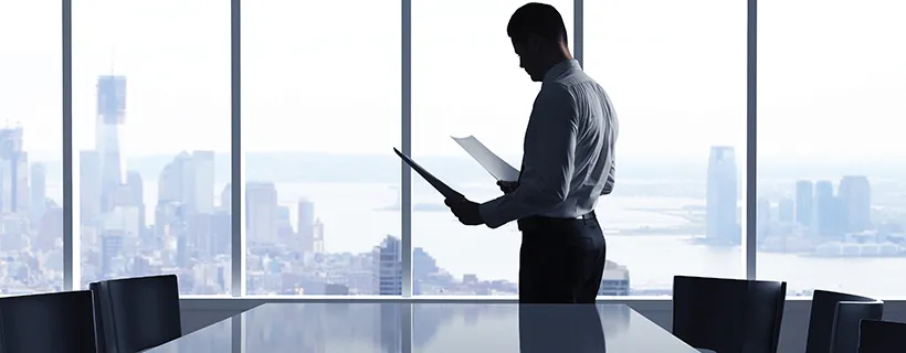 Man with DNA of a CIO looking at documents