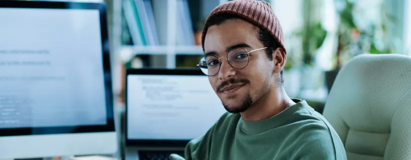 a guy with a hat wearing glasses