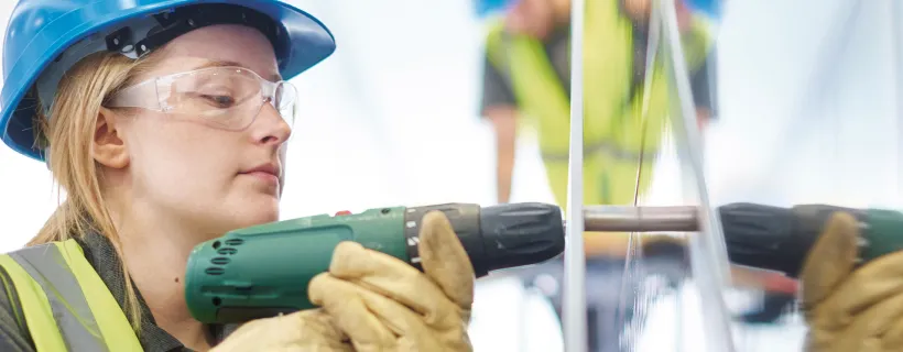 A construction worker using a power tool