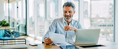 man looking at a piece of paper
