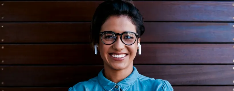 a woman with glasses wearing airpods