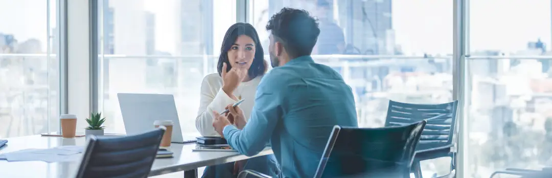 coworkers in a meeting room talking