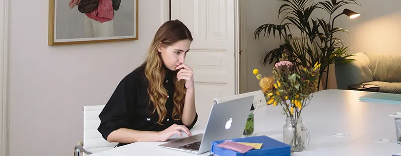 A woman working from home at her desk