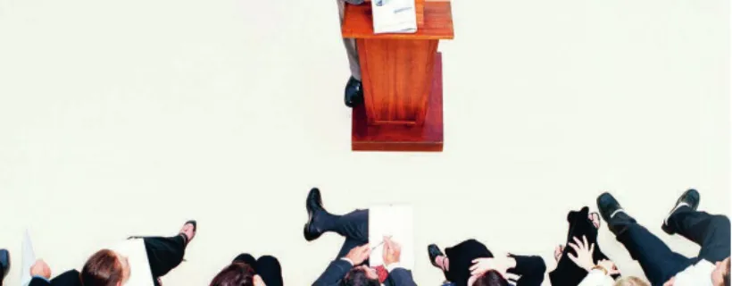 A board meeting with someone talking on a podium