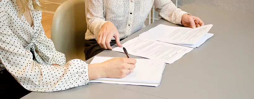 Two people working on a document