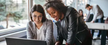 two female looking at a computer screen